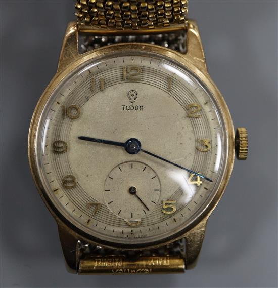 A gentlemans 1950s 9ct gold Tudor mid-size manual wind wrist watch, on associated flexible strap.